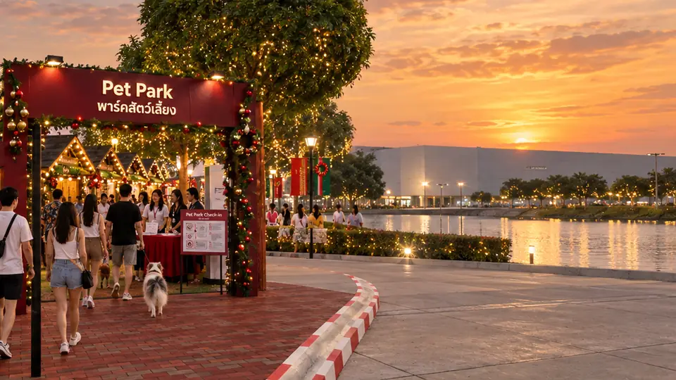 The Pet Park entrance arch with a check-in desk, a dog walking in and the lake alongside
